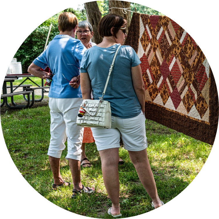 Visitors view hanging quilts