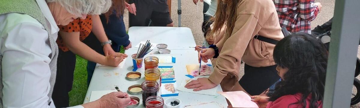 People participating in a discovery booth with watercolors.
